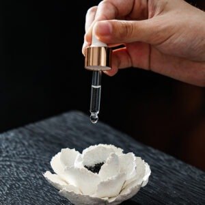 Handmade ceramic petal fragrance base with white porcelain camellia flower in Wabi Sabi style